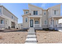 Charming townhouse featuring stone accents, a covered front porch, and inviting curb appeal at 1697 S Andes Way, Aurora, CO 80017