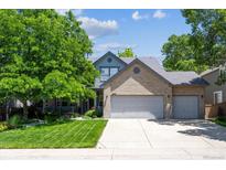 Charming two-story brick home with a three-car garage and well-manicured front yard at 13132 Pennsylvania Cir, Thornton, CO 80241