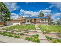 Charming home with brick accents, solar panels, landscaped front yard, and a spacious driveway at 3451 Highland Pl, Westminster, CO 80031