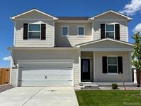 Charming two-story home featuring a spacious two-car garage, well-manicured lawn, and inviting front entrance at 2235 Alyssa St, Fort Lupton, CO 80621