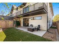 Private backyard with cozy patio featuring a fire pit and outdoor seating, perfect for entertaining at 5240 N Raleigh St, Denver, CO 80212