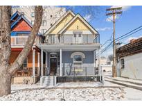 Charming two-story home with a porch, balcony, and a yellow gable in a vibrant neighborhood at 425 W 13Th Ave, Denver, CO 80204