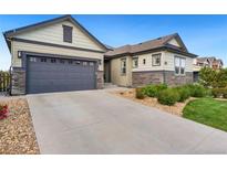 Charming single Gathering home featuring a two car garage and beautifully landscaped front yard at 17637 W 87Th Ave, Arvada, CO 80007