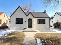 Charming Tudor home featuring a well-manicured lawn and inviting front entrance at 1768 Krameria St, Denver, CO 80220