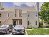 Charming townhome featuring a deck, a well-maintained lawn, and convenient parking at 1005 S Miller St # 102, Lakewood, CO 80226