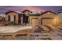 Charming home featuring stone accents, a two-car garage, and well-maintained landscaping at 11541 Quartzite Way, Parker, CO 80138
