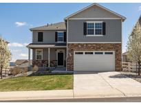 Charming two-story home featuring a landscaped yard and an attached two-car garage at 6024 High Timber Cir, Castle Rock, CO 80104