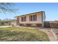 Charming two-story home with an attached garage, tidy lawn and brick accents at 1207 S Memphis St, Aurora, CO 80017