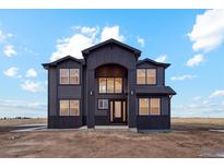 Beautiful two-story home with black siding and a modern architectural design on a spacious lot at 49601 E 56Th Ave, Bennett, CO 80102
