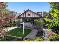 Charming home with a landscaped front yard, stone walkway, and a 'Coming Soon' sign at 815 S Gaylord St, Denver, CO 80209