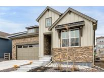 Charming two-story home with a stone and siding exterior and well-maintained landscaping at 8175 Sewanee Peak St, Littleton, CO 80125