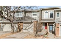 Charming townhouse featuring a brick facade, attached garages, and a well-maintained walkway to the front doors at 12089 W Chenango Dr, Morrison, CO 80465