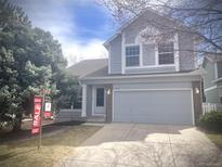 Charming two-story home featuring a well-maintained lawn, attached two-car garage, and inviting front entrance at 2414 S Gray Dr, Lakewood, CO 80227