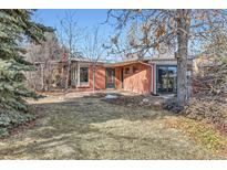 Charming brick home featuring a well-maintained front yard and mature trees providing shade at 1235 Ivy St, Denver, CO 80220