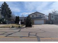Charming two-story home with a well-manicured front lawn and a two-car garage on a tree-lined street at 2325 15Th Ave, Longmont, CO 80503