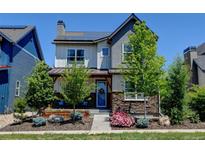 Charming two-story home featuring stone accents, covered porch, and solar panels at 1362 Golden Eagle Way, Louisville, CO 80027