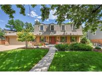 Charming brick home with a well-manicured lawn and a red front door at 7030 S Fillmore Ct, Centennial, CO 80122