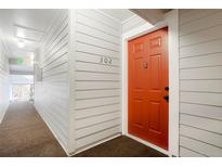 Condo 302 features a vibrant red front door, providing a welcoming entrance to the property at 7665 E Eastman Ave # 302B, Denver, CO 80231