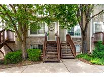 Charming townhome with inviting staircases leading to front doors and mature trees at 1885 S Quebec Way # G 106, Denver, CO 80231