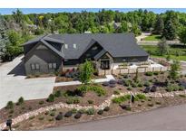 Stunning home featuring a modern design, lush landscaping, and inviting curb appeal at 5859 E Ida Pl, Greenwood Village, CO 80111