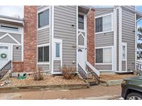 Stylish townhome featuring brick and grey siding, complete with landscaped entryway and front door access at 5510 W 80Th Pl # 314, Arvada, CO 80003