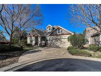 Charming home featuring a landscaped yard, two-car garage, and elegant architectural details at 1430 Bluefield Ave, Longmont, CO 80504