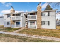 Inviting two-story condo with stone accents and a cozy, covered balcony for relaxing outdoors at 14454 E Colorado Dr # 103, Aurora, CO 80012