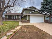 Charming two-story home featuring an attached two car garage and manicured lawn and garden at 6640 S Heritage W Pl, Centennial, CO 80111