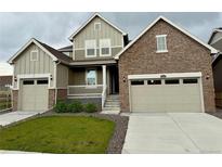 Charming two-story home featuring a stone facade, attached two-car garage, and landscaped front yard at 17632 Datura St, Broomfield, CO 80023