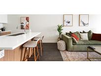 A stylish living room featuring a modern kitchen island, comfortable seating, and elegant decor at 2880 Zuni St # 309, Denver, CO 80211