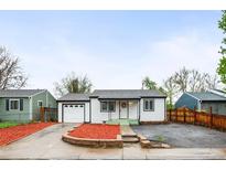 Charming single-story home with a well-manicured lawn and an attached one-car garage at 7841 Oneida St, Commerce City, CO 80022