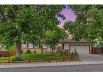 Charming one-story home featuring a well-maintained yard, mature trees, and an attached two-car garage at 16839 E Amherst E Ave, Aurora, CO 80013