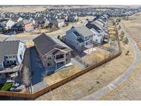 Aerial view of new construction homes in a suburban neighborhood, featuring fenced yards and walking paths at 17097 W 87Th Ave, Arvada, CO 80007