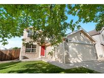 Inviting two-story home with a red door and a well-maintained lawn at 18897 E Linvale Pl, Aurora, CO 80013