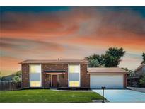 Charming brick and siding two-story home with a well-maintained lawn and attached two-car garage at 10932 W 107Th Ave, Broomfield, CO 80021