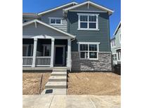Charming two-story home with a covered porch, stone accents, and a modern design in a Gathering-friendly neighborhood at 15267 Fillmore St, Thornton, CO 80602