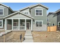 Charming two-story home with a covered front porch and stone accents at 15267 Fillmore St, Thornton, CO 80602