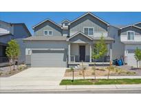 Charming two-story home with a well-maintained lawn, garage, and welcoming front porch at 1417 Bloom St, Brighton, CO 80601