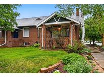 Charming brick home with well-manicured lawn and inviting front porch at 1602 Garfield St, Denver, CO 80206