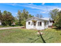 Charming single-story home featuring a well-manicured lawn and inviting entrance at 310 Jay St, Lakewood, CO 80226