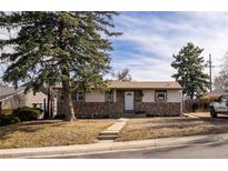 Charming single-story home with stone accents, landscaped front yard, and mature trees in established neighborhood at 780 Campo St, Denver, CO 80221
