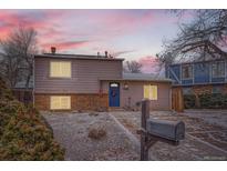 Charming home exterior with a well-maintained front yard and inviting blue front door at 17877 E Oxford Pl, Aurora, CO 80013