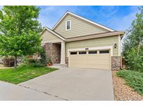 Charming two-story home with a two-car garage, stone accents, and well-maintained landscaping at 6046 Gilbert Way, Golden, CO 80403