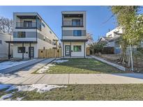 Modern two-story home featuring a balcony, manicured lawn, and contemporary design elements at 1715 Grove St, Denver, CO 80204