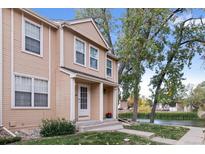 Charming townhouse with a covered front porch, located near a tranquil pond and lush trees at 12131 Bannock St # C, Westminster, CO 80234