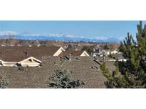 Panoramic distant view of snow capped mountains, seen from the rooftop level within the community at 6193 Brantly Ave, Castle Rock, CO 80104