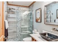Modern bathroom featuring a glass enclosed shower, beautiful stone countertops, and stylish fixtures at 112 Grey Squirrel Ln, Breckenridge, CO 80424
