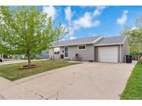 Charming one-story home with well-maintained lawn, mature tree, and driveway leading to a one-car garage at 1182 S Alcott St, Denver, CO 80219