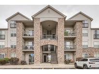 Beautiful condo building with stone accents and multiple balconies on a cloudy day at 7292 S Blackhawk St # 2-204, Englewood, CO 80112