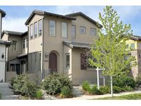 Charming two-story home with neutral stucco exterior and landscaped front yard at 15525 W La Salle Ave, Lakewood, CO 80228